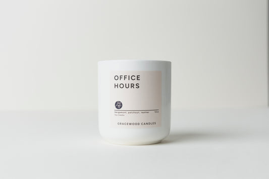 White candle labeled 'Office Hours' by Gracewood Candles on a white background