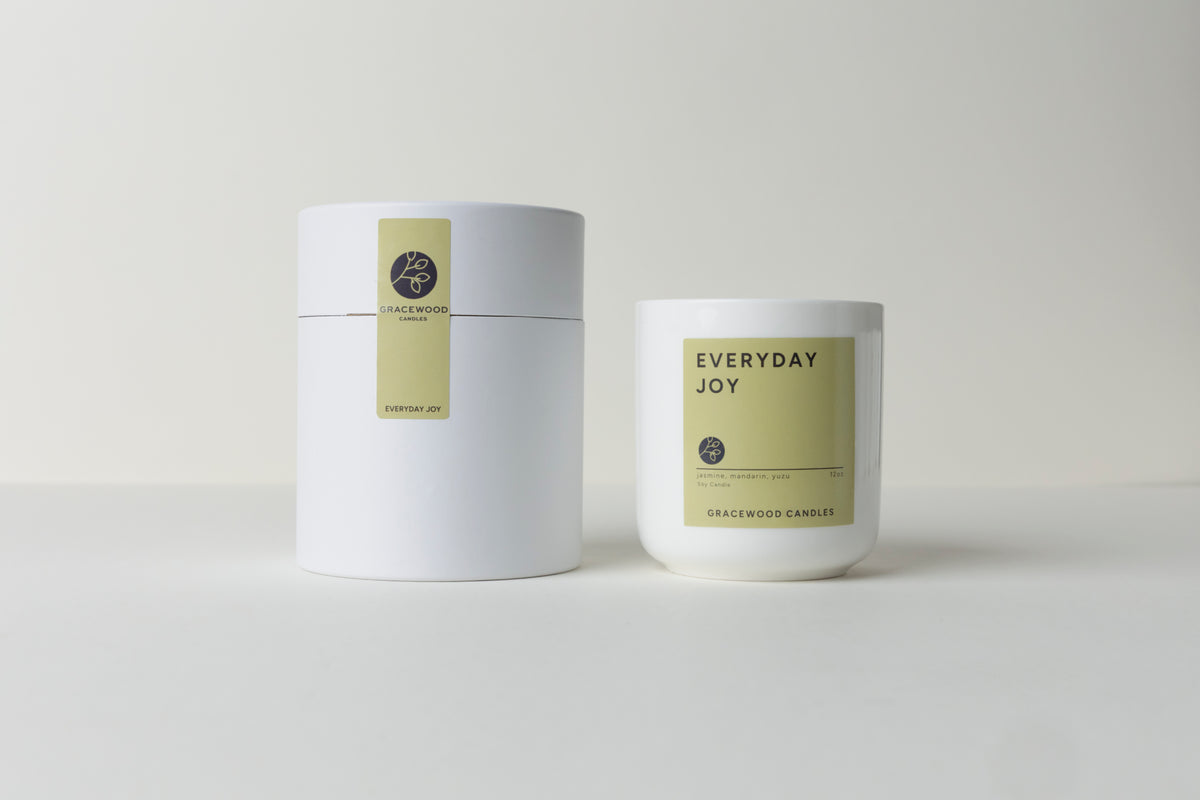 Two candles labeled 'Everyday Joy' on a white background