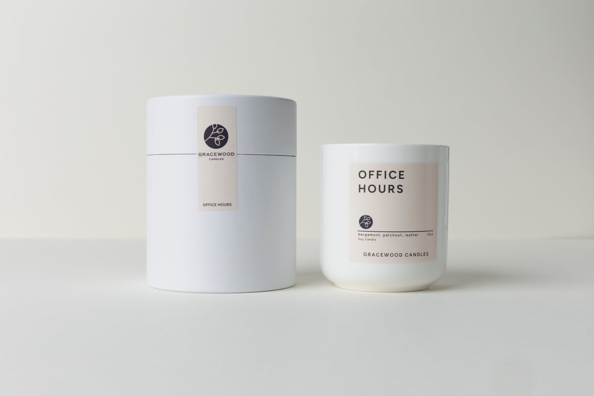 Two candles labeled 'Office Hours' by Gracewood Candles on a light gray background