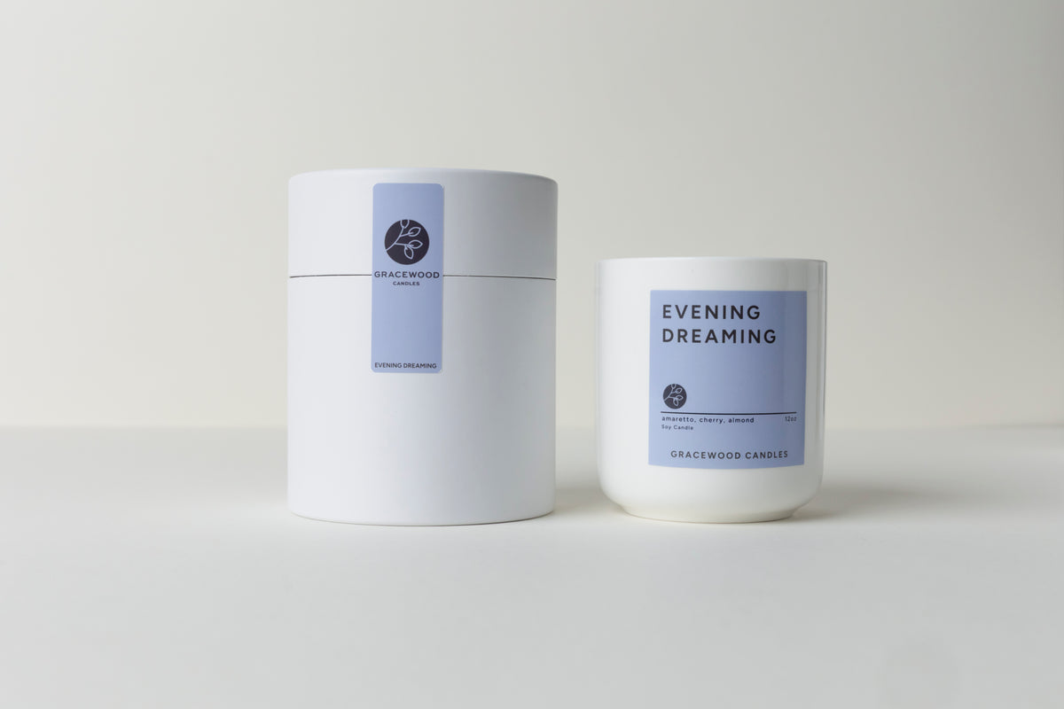 Two candles with labels on a light gray background