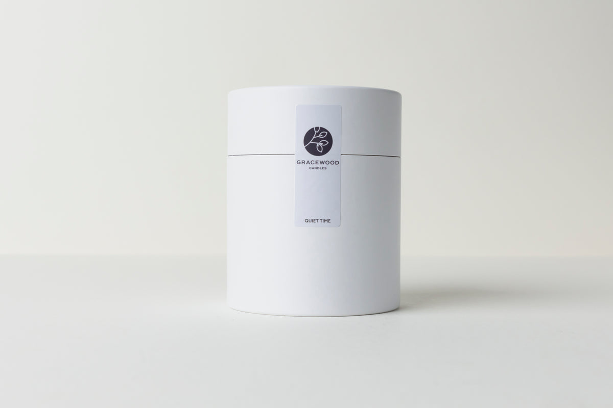 White cylindrical container with a label on a white background