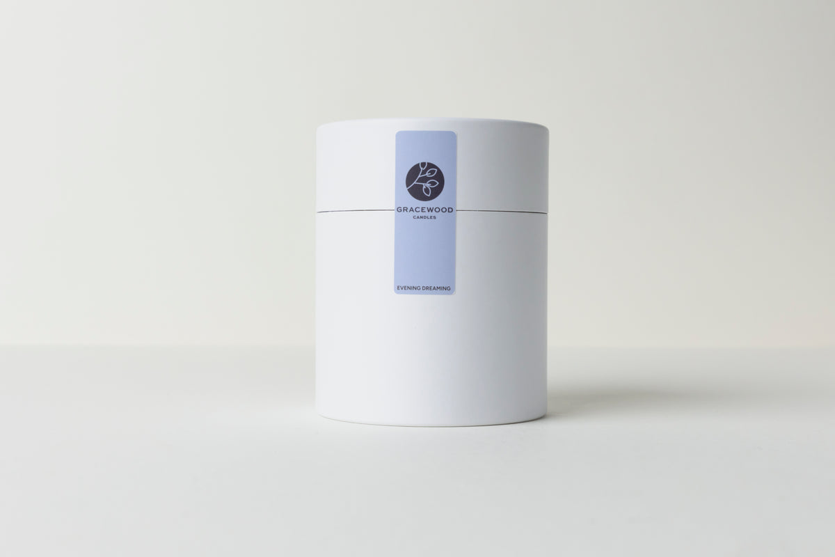 White cylindrical container with a blue label on a white background