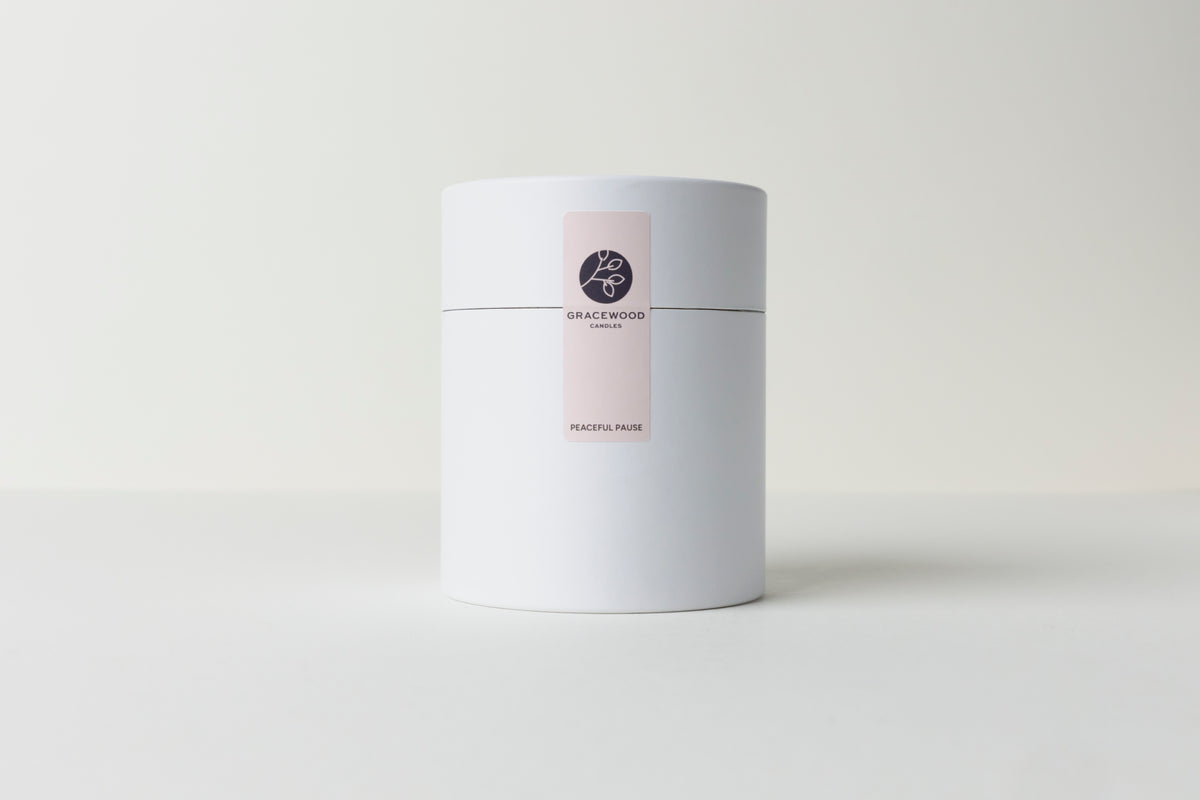 White cylindrical container with a label on a white background