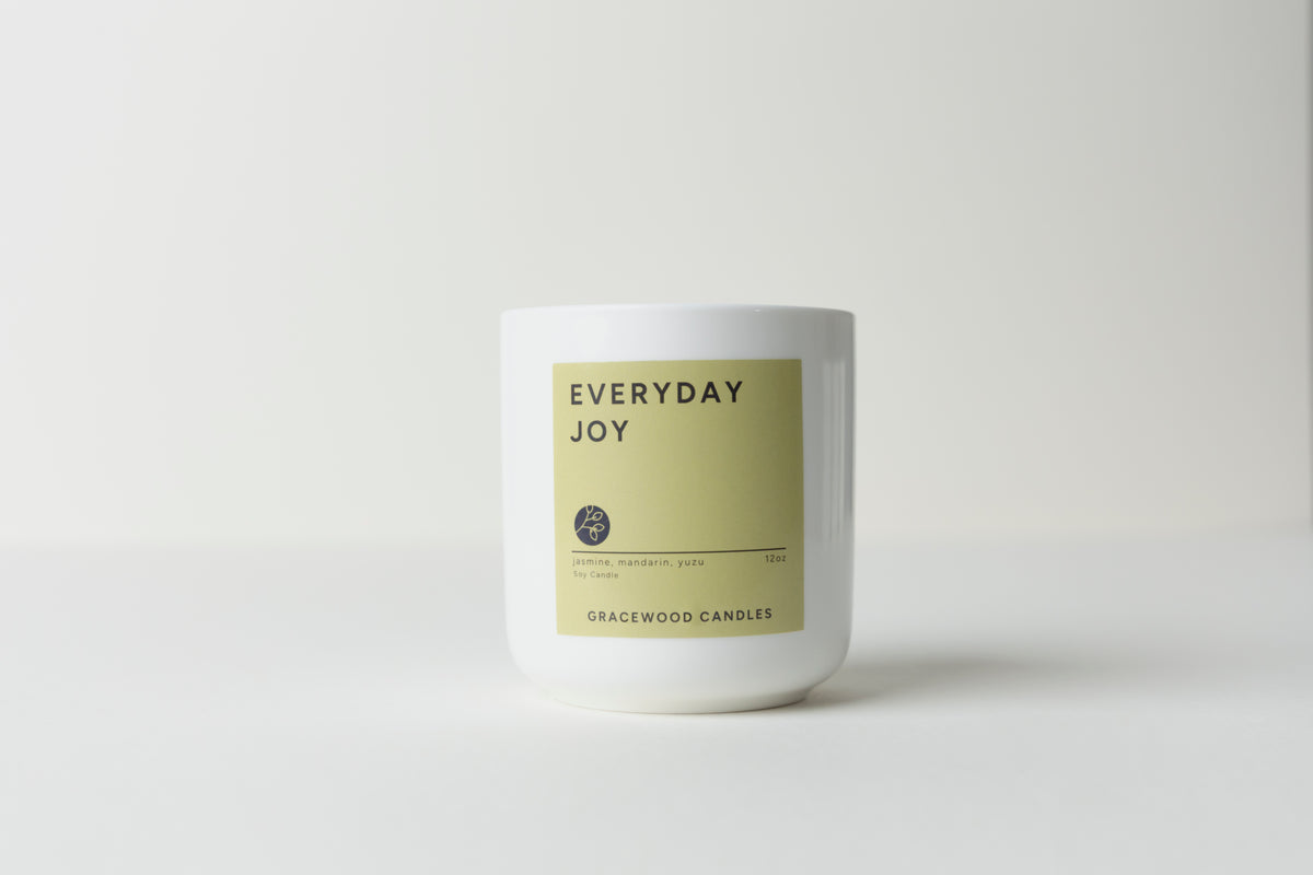 Candle labeled 'Everyday Joy' on a white background