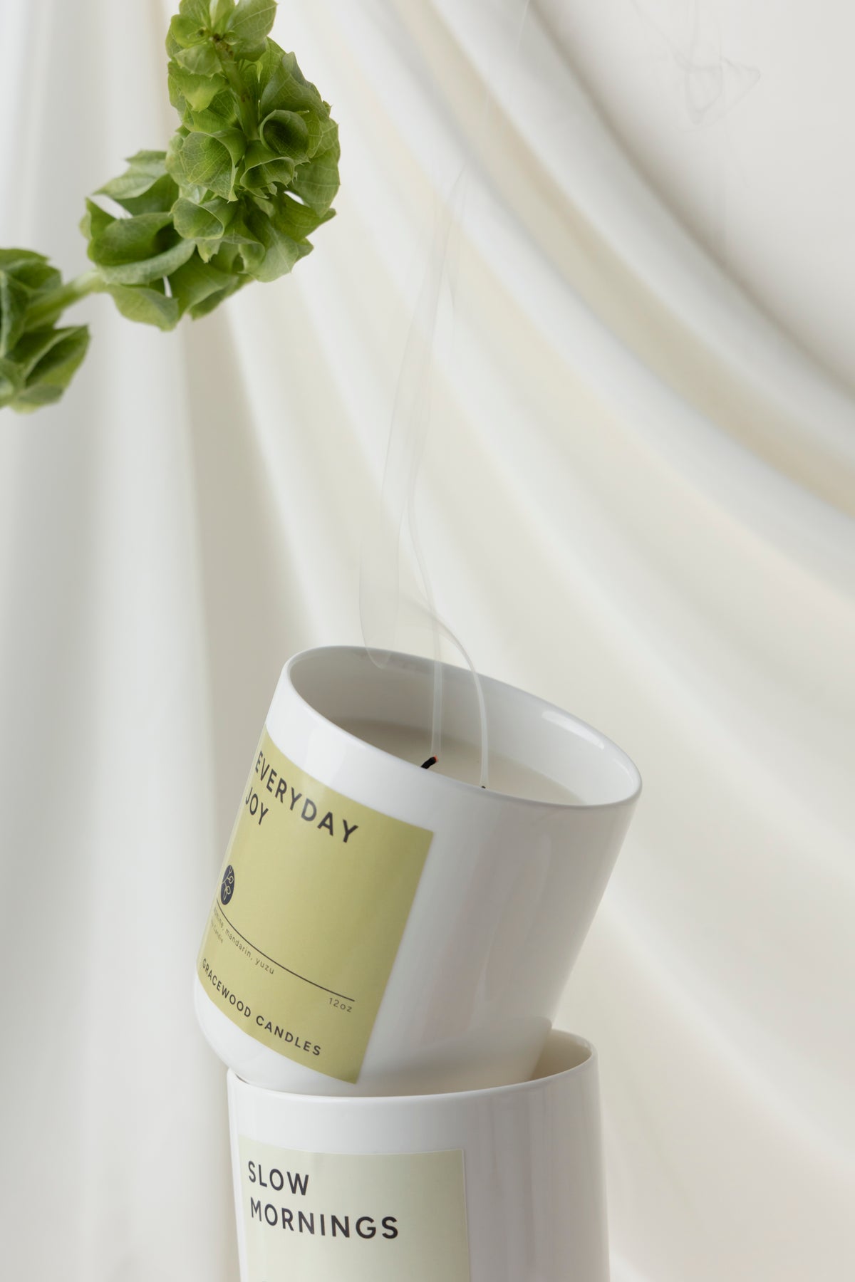 Two candles with labels on a white background