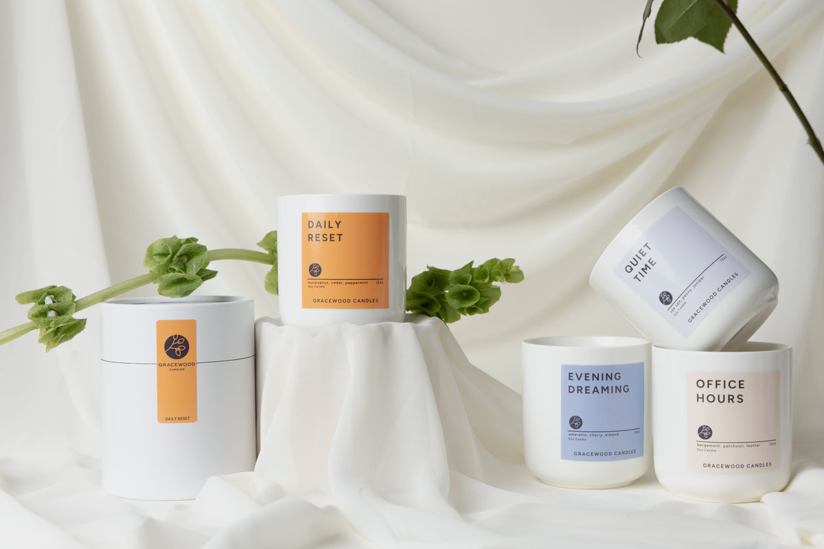 Set of candles with labels on a white fabric background