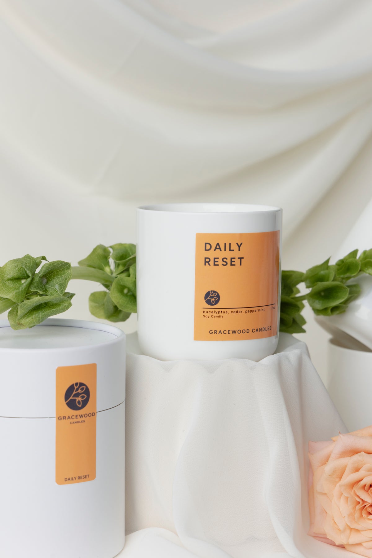 Gracewood candle labeled 'Daily Reset' with a white background and decorative elements.