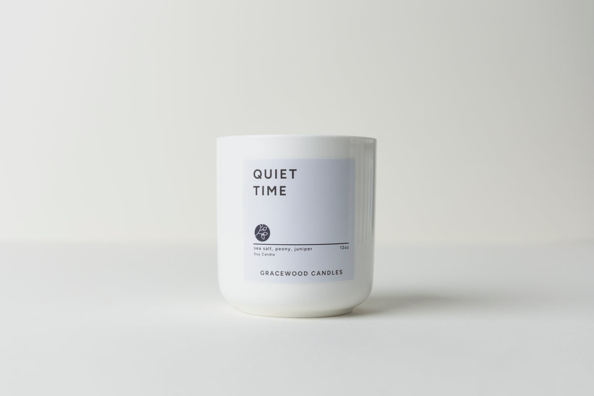 White candle labeled 'Quiet Time' by Gracewood Candles on a white background