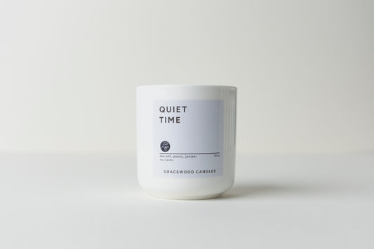 White candle labeled 'Quiet Time' by Gracewood Candles on a white background