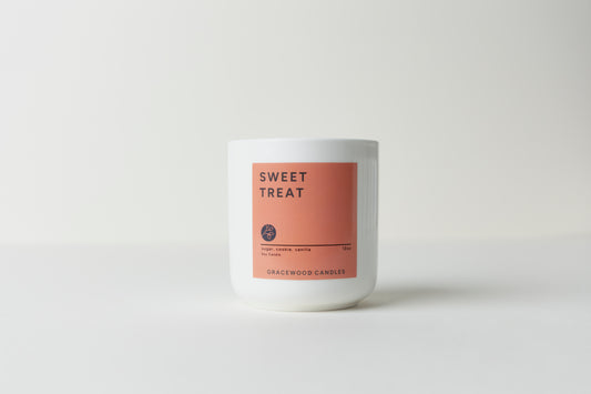 Candle with a 'Sweet Treat' label on a white background
